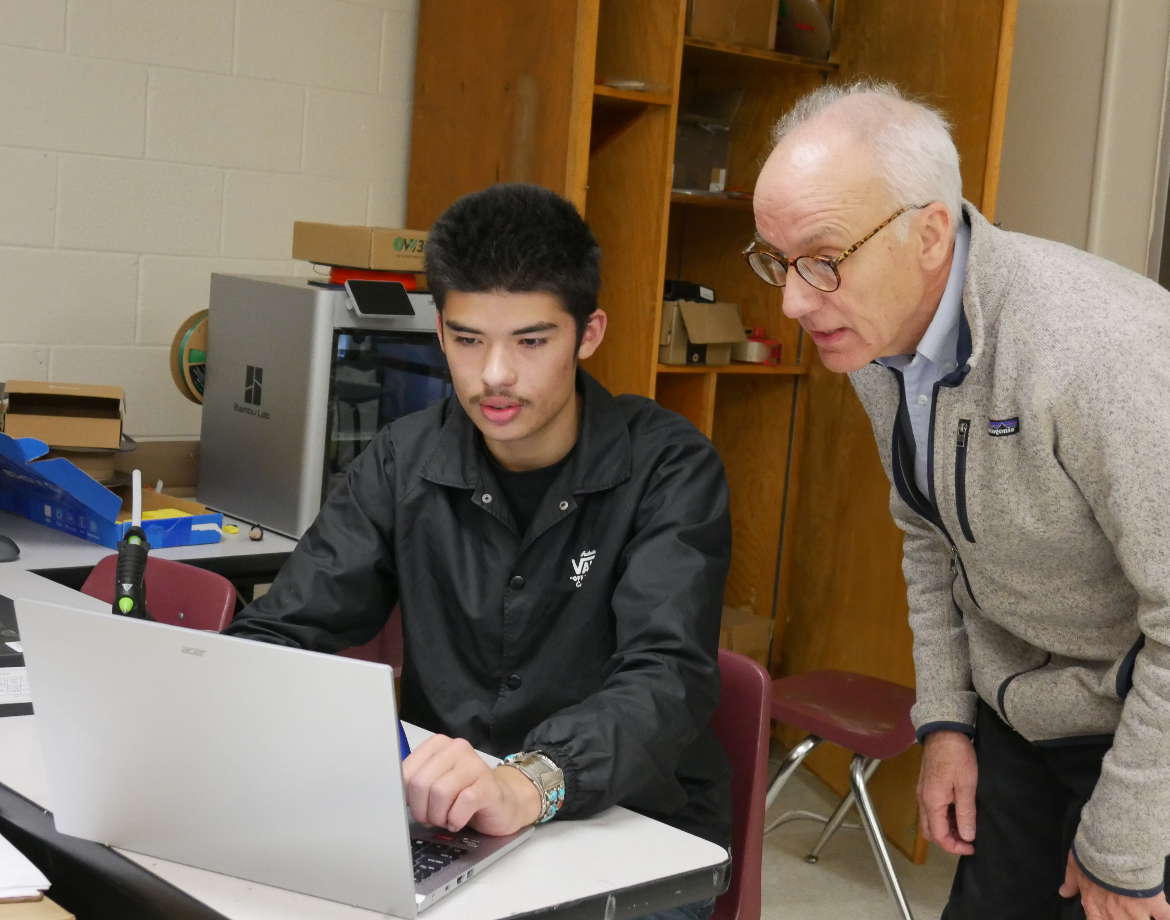 Steve Cox works with McCurdy Charter School volunteer Gabe Zak